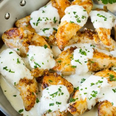 A pan of garlic chicken in a creamy parmesan sauce.