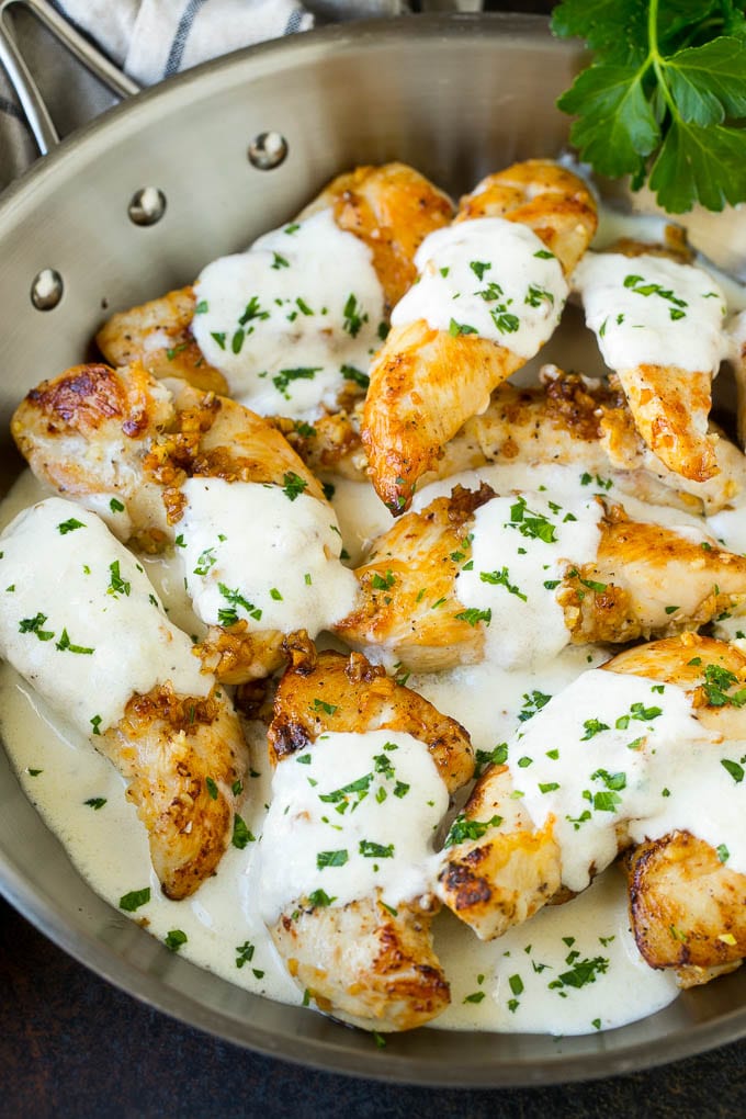 A pan of garlic chicken in a creamy parmesan sauce.