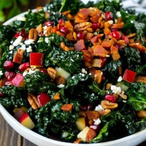 Apple kale salad topped with bacon and pecans.