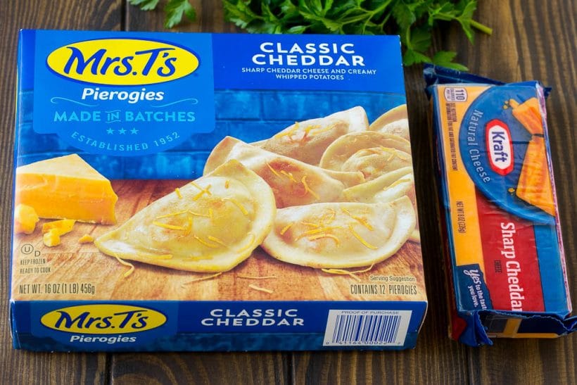 A box of pierogies and a block of cheddar cheese.