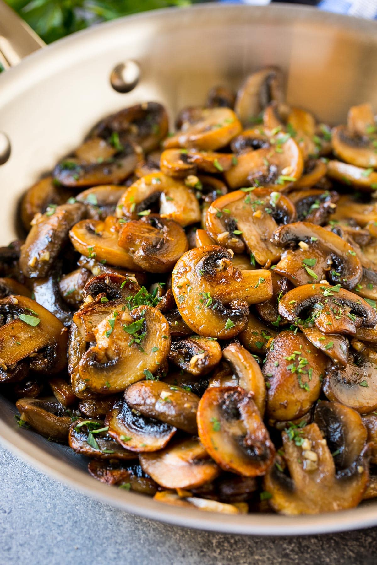 A pan of mushrooms cooked with butter and garlic.