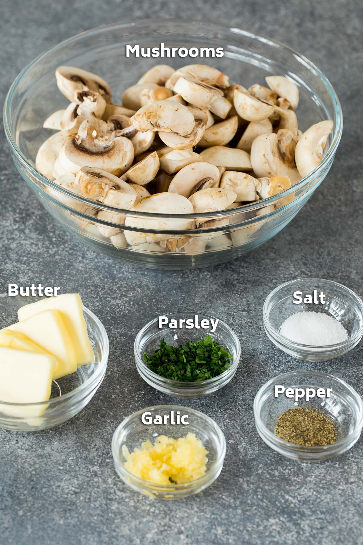 Bowls of ingredients including mushrooms, butter, garlic and seasonings.