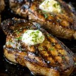 The best steak marinade with grilled steaks topped with herb butter.