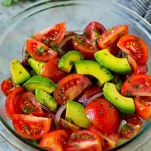 Tomato avocado salad with red onion and a cilantro lime dressing.