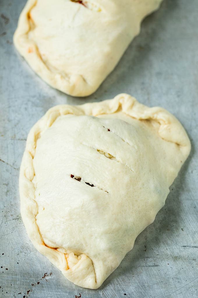 Unbaked calzones ready to go into the oven.