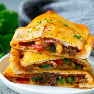 Calzone halves stuffed with sausage, peppers, cheese and pepperoni.