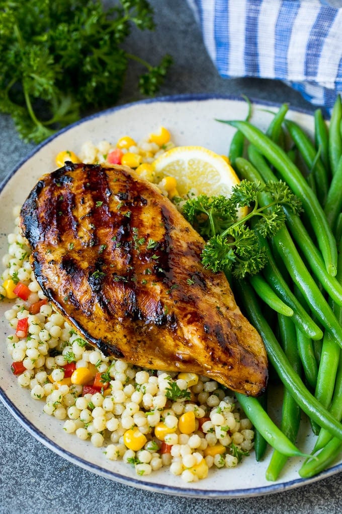 Grilled chicken flavored with chicken marinade served with couscous and green beans.