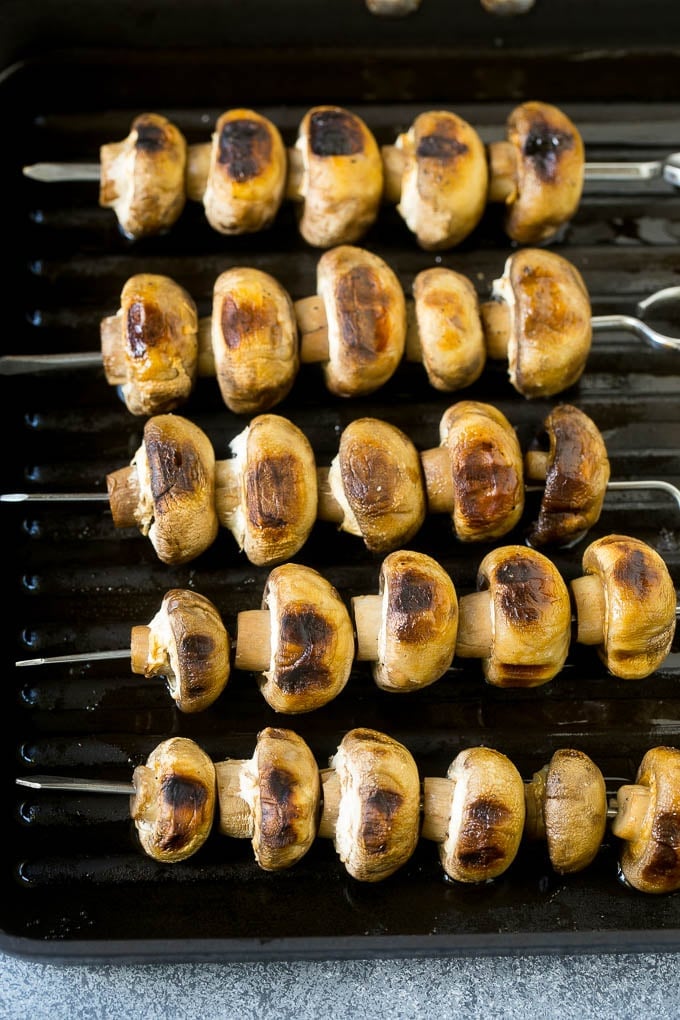 Mushroom skewers cooked on a grill pan.