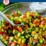 This Israeli salad is a refreshing blend of chopped cucumbers, tomatoes, onions and peppers, all tossed in a lemon dressing.