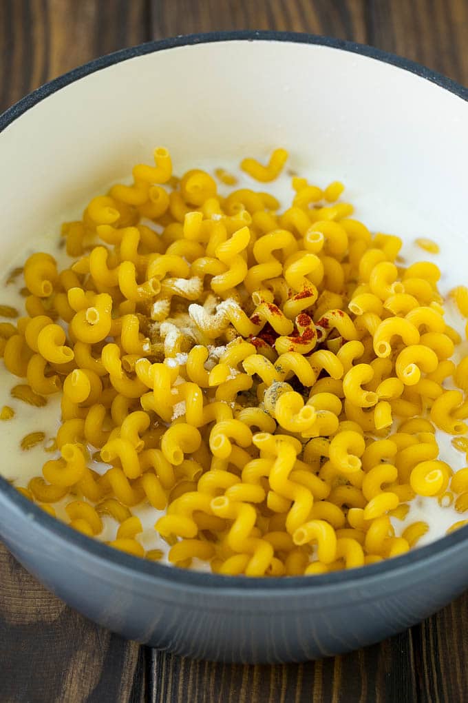 Pasta with milk and spices in a pot.