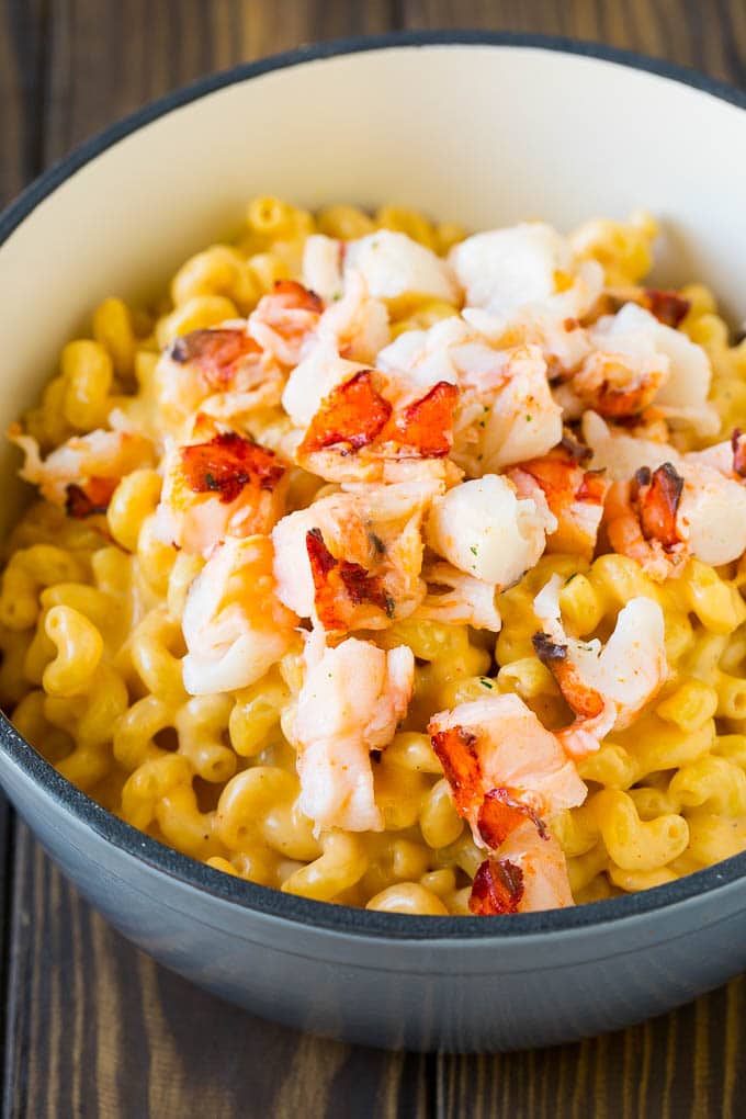 Stove top mac and cheese topped with pieces of cooked lobster.