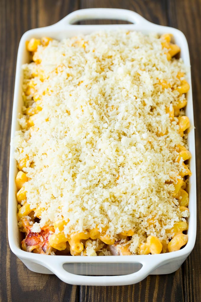 A casserole dish of lobster mac and cheese topped with panko breadcrumbs.