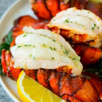 Broiled lobster tails topped with garlic butter.