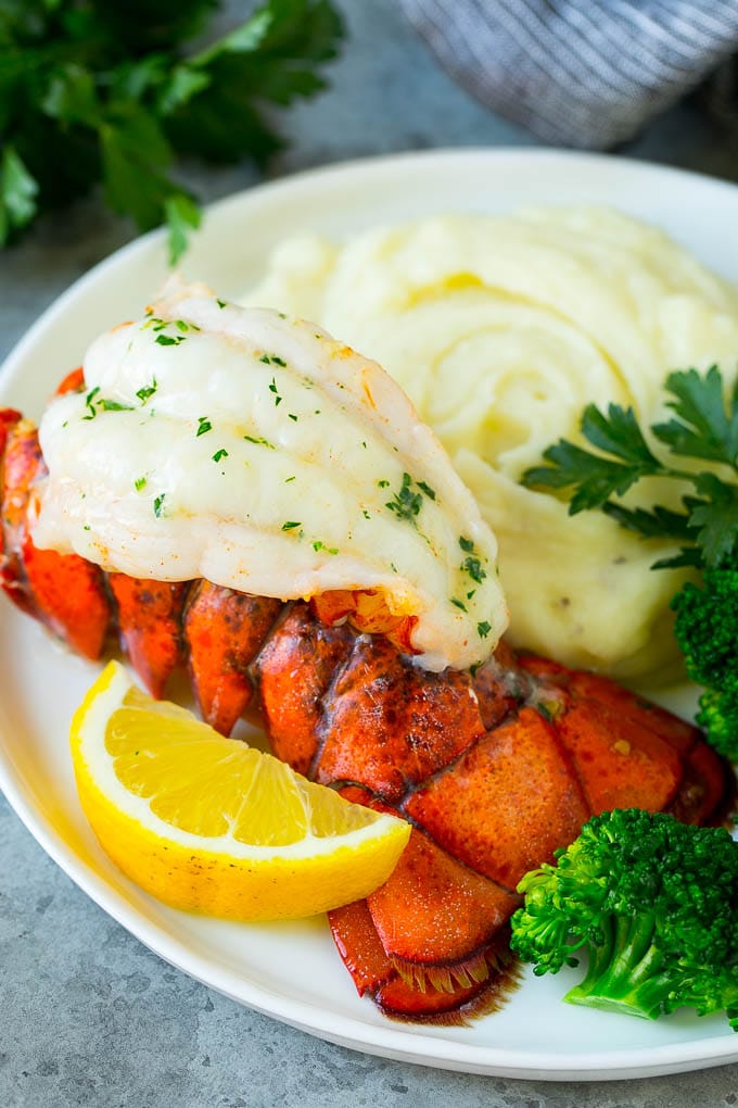 A lobster tail served with mashed potatoes and broccoli.