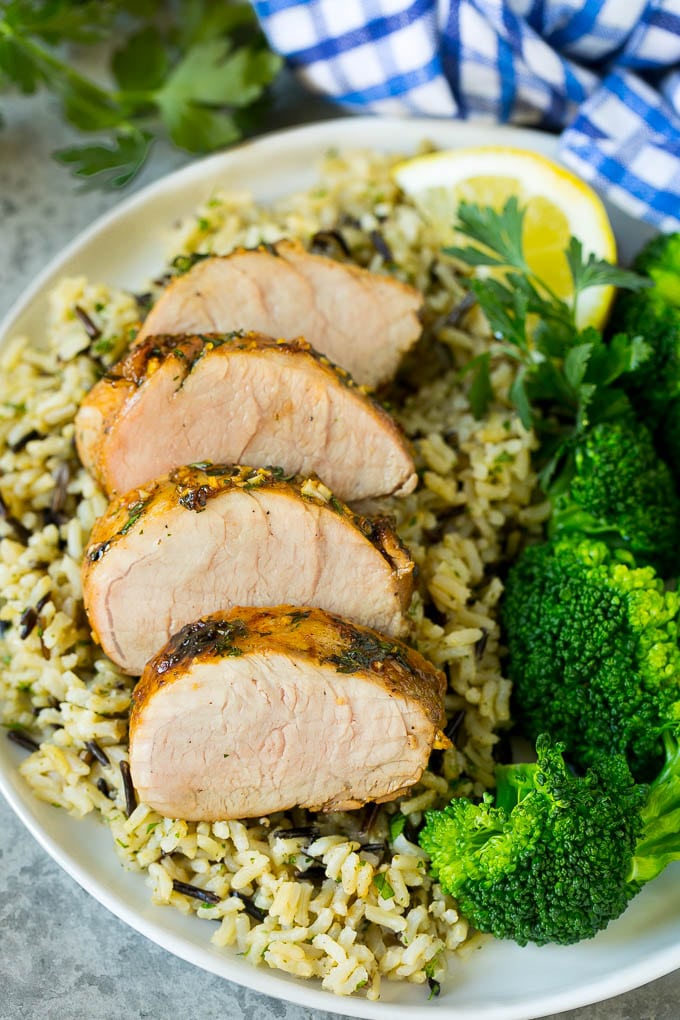 Pork tenderloin marinade over sliced pork, served with rice and broccoli.