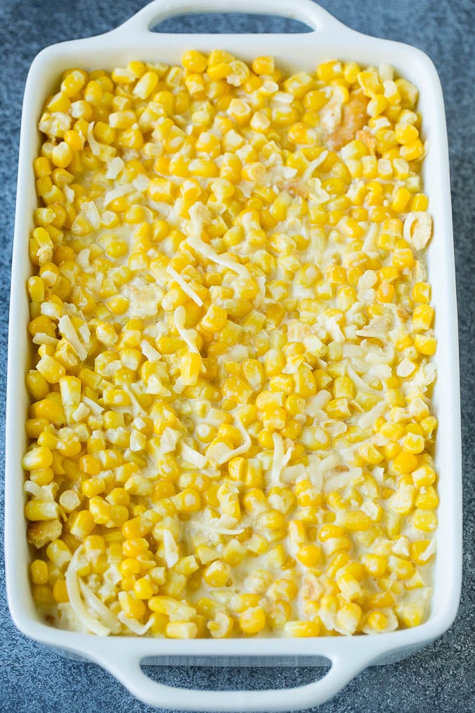 Scalloped Corn | Corn Casserole #corn #casserole #cheese #sidedish #dinner #dinneratthezoo A baking pan of corn in a creamy custard mixture.