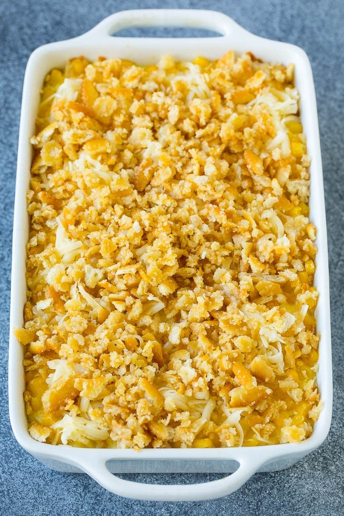 Scalloped corn topped with crushed crackers and shredded cheese.