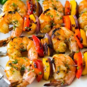 Shrimp kabobs with marinated grilled shrimp, red and yellow peppers and onions.