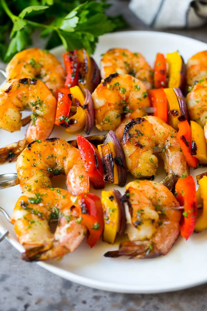 Shrimp kabobs with marinated grilled shrimp, red and yellow peppers and onions.
