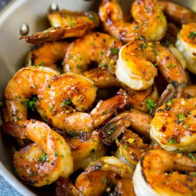 Shrimp marinade over cooked shrimp, topped with parsley.