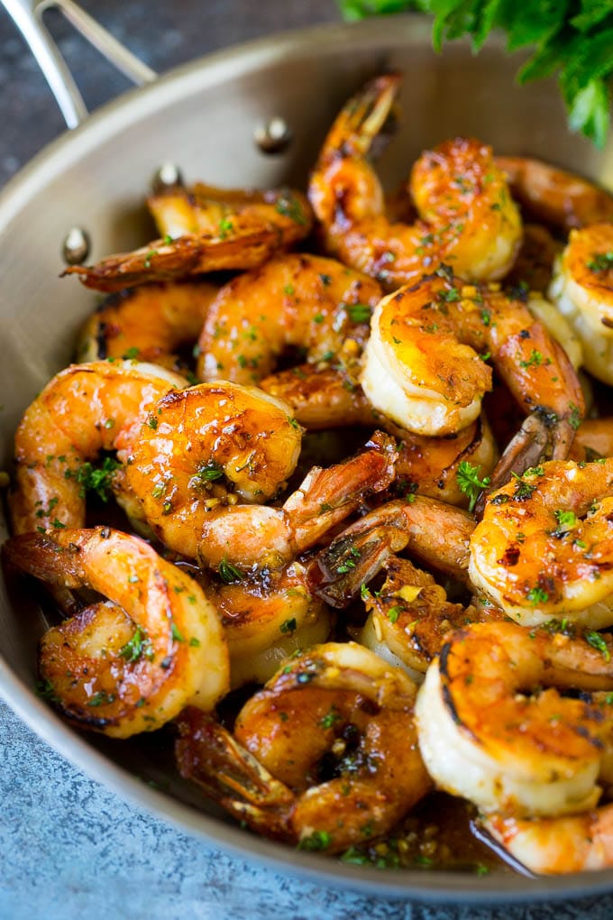 Shrimp marinade over cooked shrimp, topped with parsley.