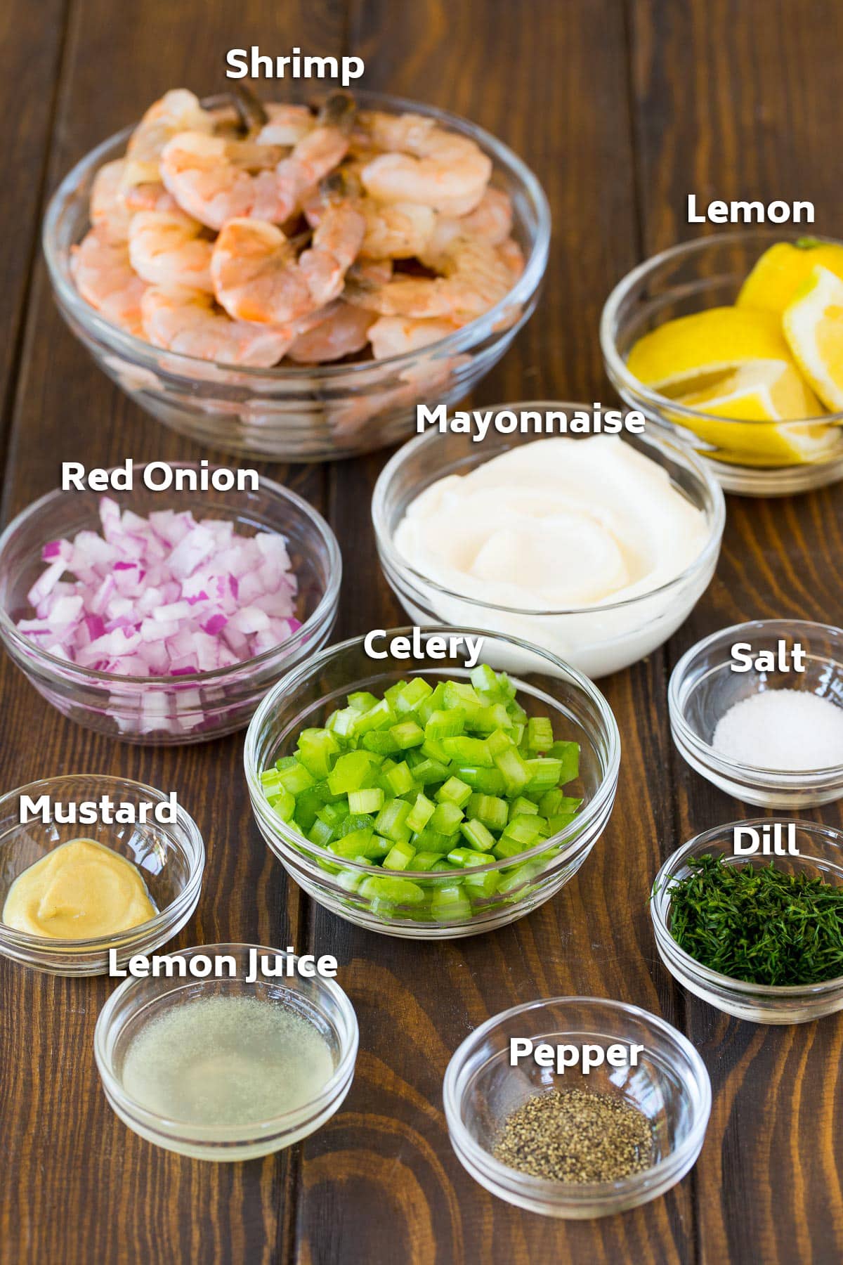 Bowls of ingredients including shrimp, vegetables, mayonnaise, mustard and seasonings.