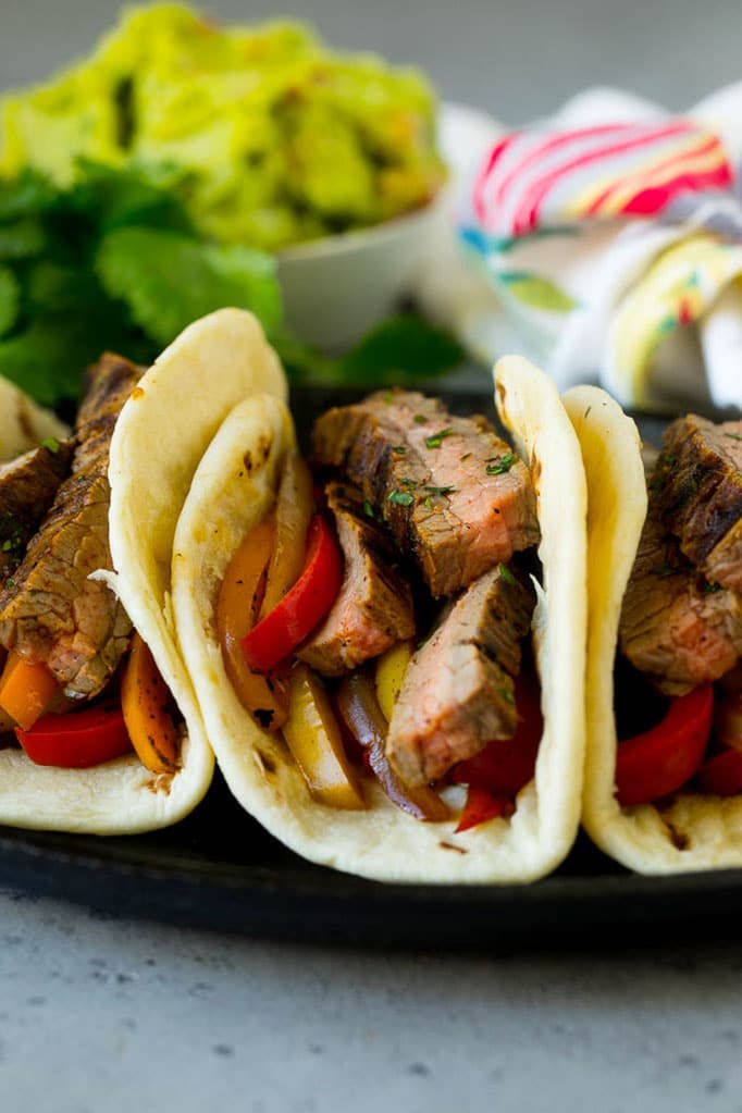 Tortillas filled with steak and sauteed peppers and onions.