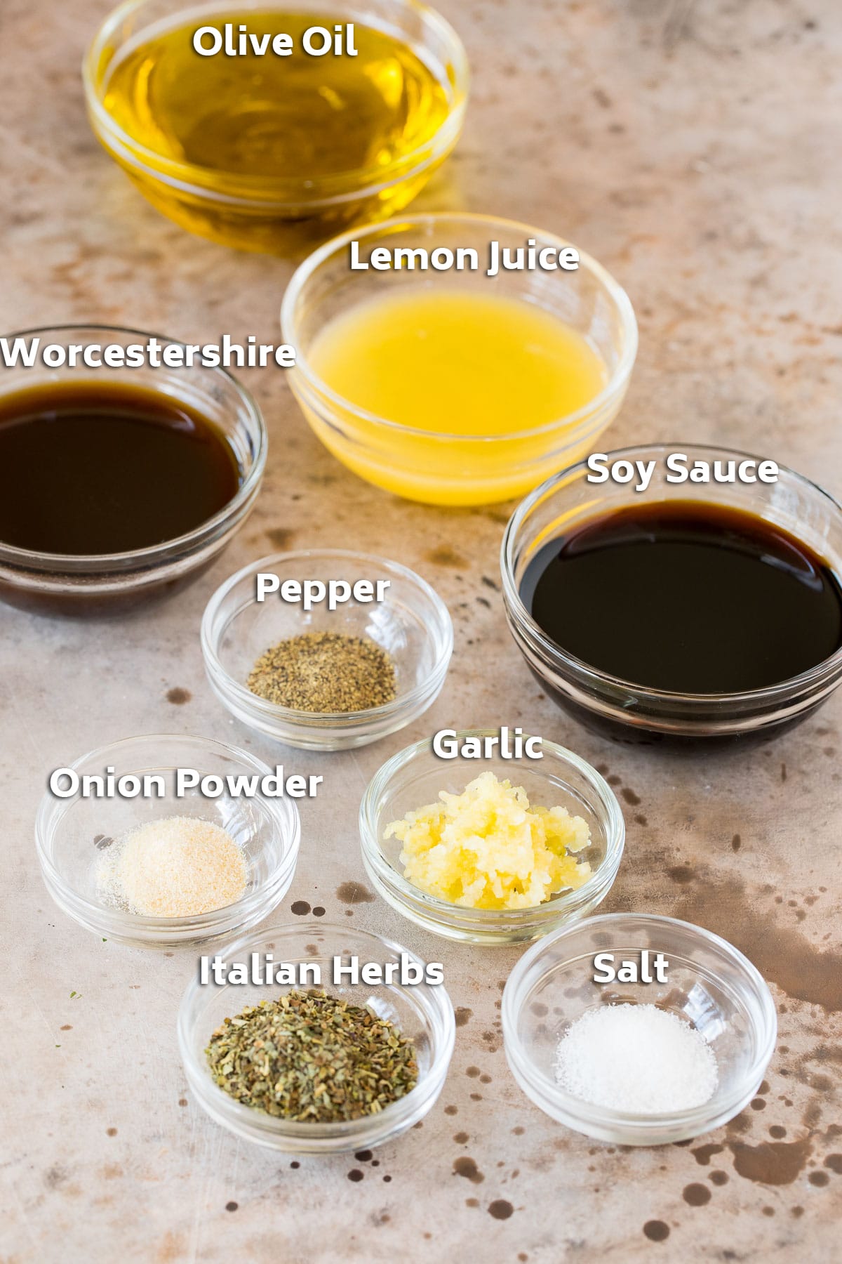 Bowls of ingredients including olive oil, soy sauce, garlic and seasonings.