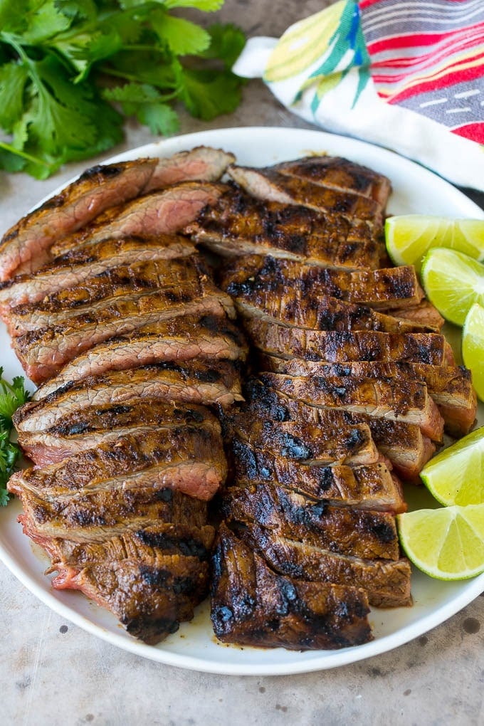 Sliced grilled flank steak on a plate.