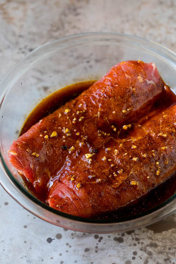 Marinated flank steak in a bowl.