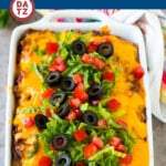 This taco casserole is layers of tortilla chips, refried beans and beef, all topped with plenty of cheese and baked to perfection.