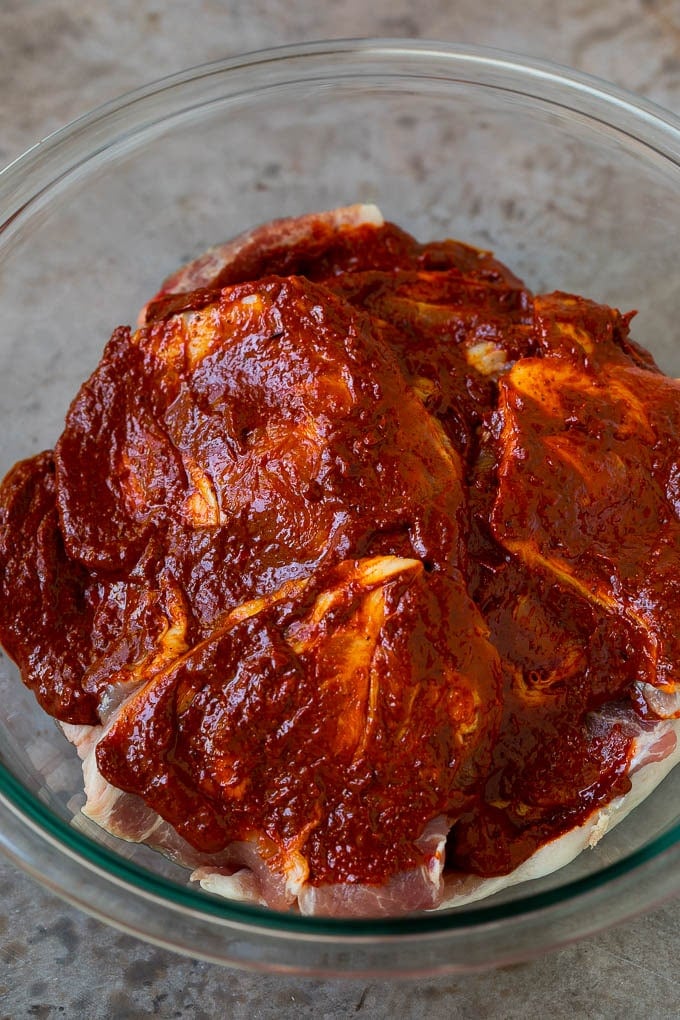 Sliced pork shoulder coated in a chile based marinade.