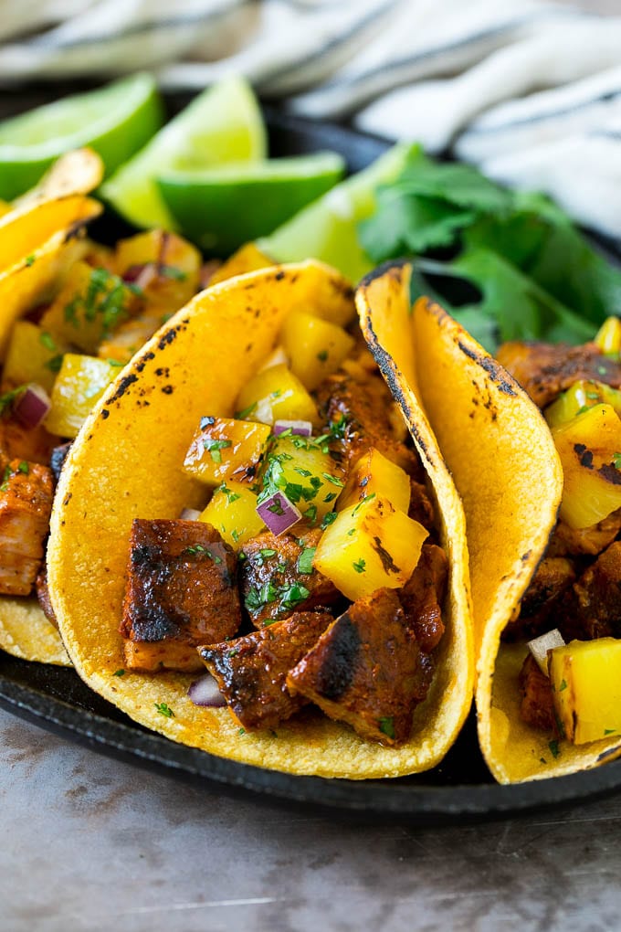 Tacos al pastor stuffed with grilled pork, pineapple, red onion and cilantro.
