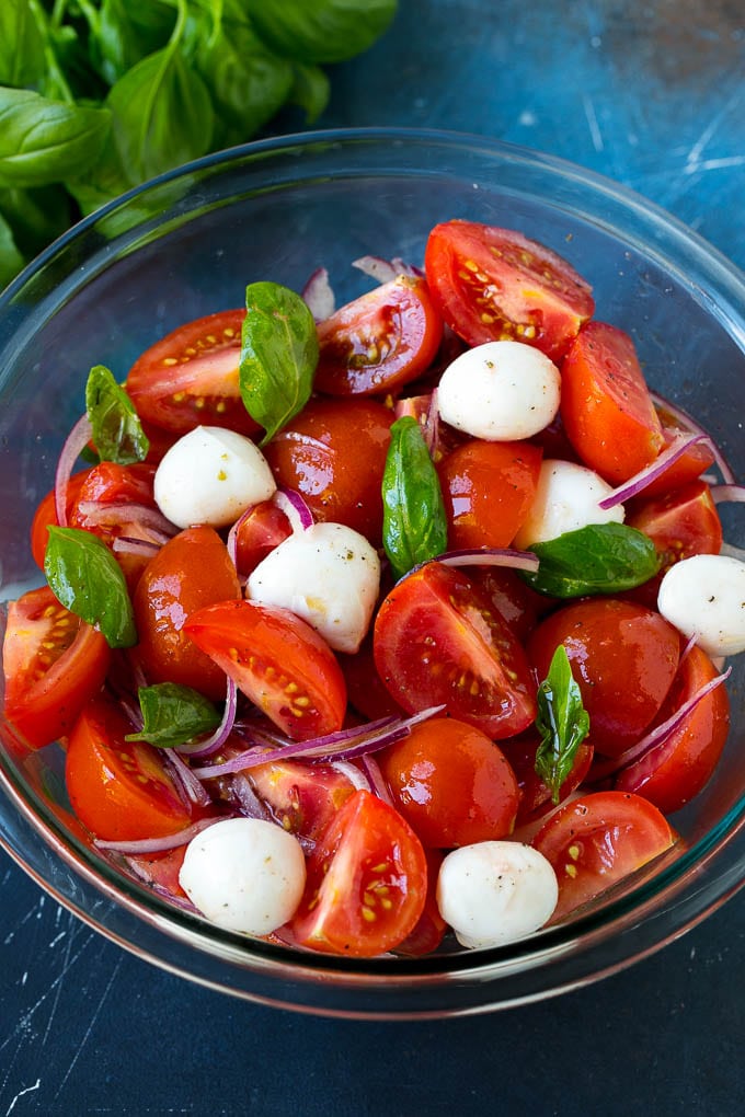 Tomato salad with fresh mozzarella cheese, red onion and basil.