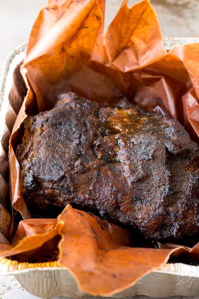 Smoked brisket in a metal pan.