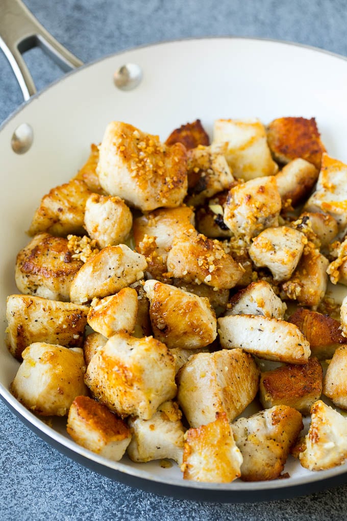 Seared chicken and garlic in a skillet.