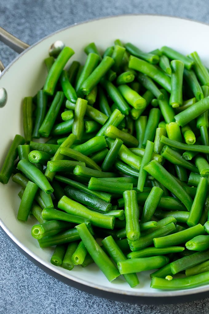 Cooked green beans in a pan.