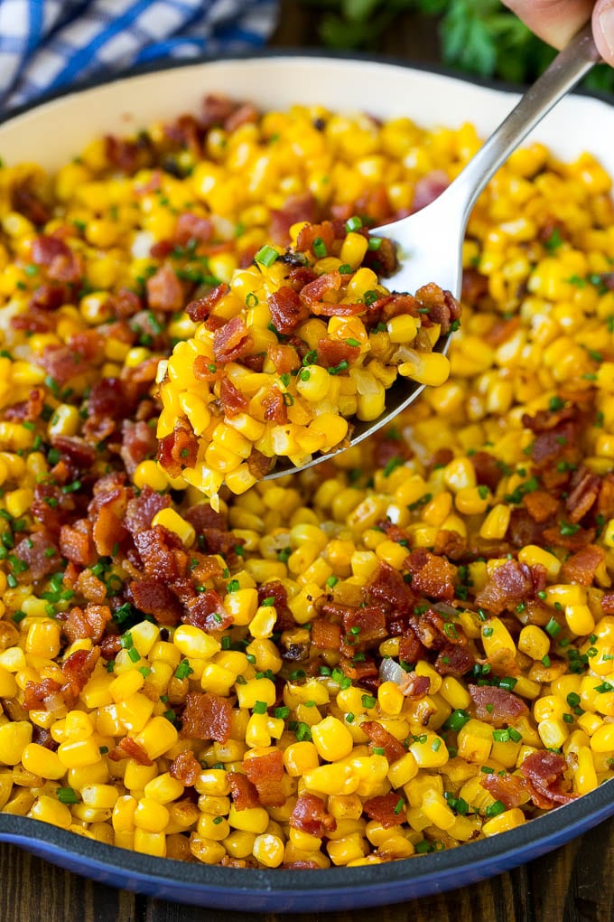A spoonful of fried corn made with bacon and onions.