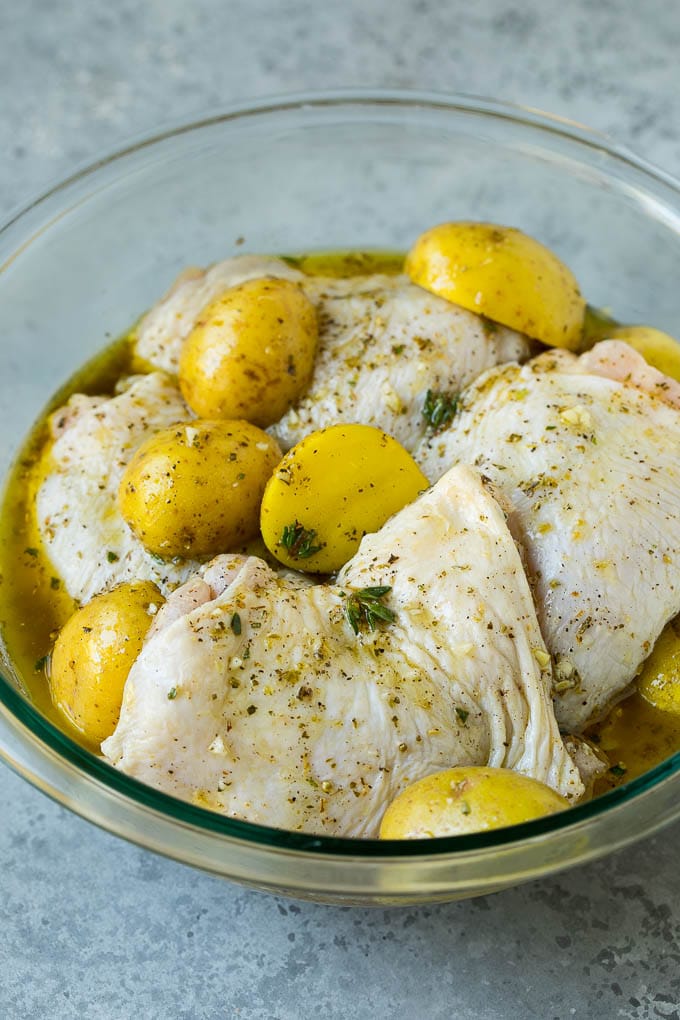 Chicken thighs and potatoes in a garlic and herb marinade.