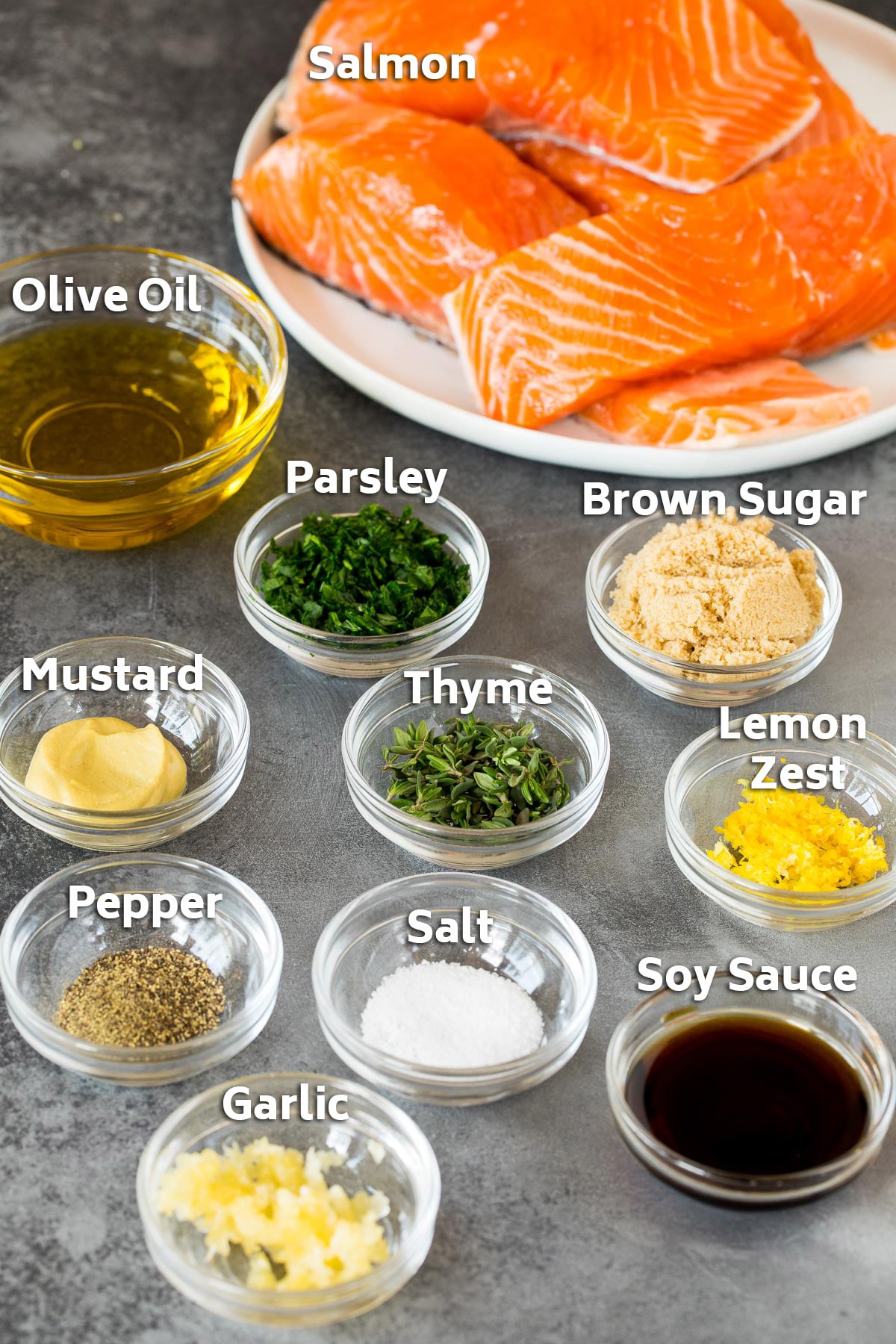 Ingredients including salmon fillets, olive oil, soy sauce, herbs and spices.