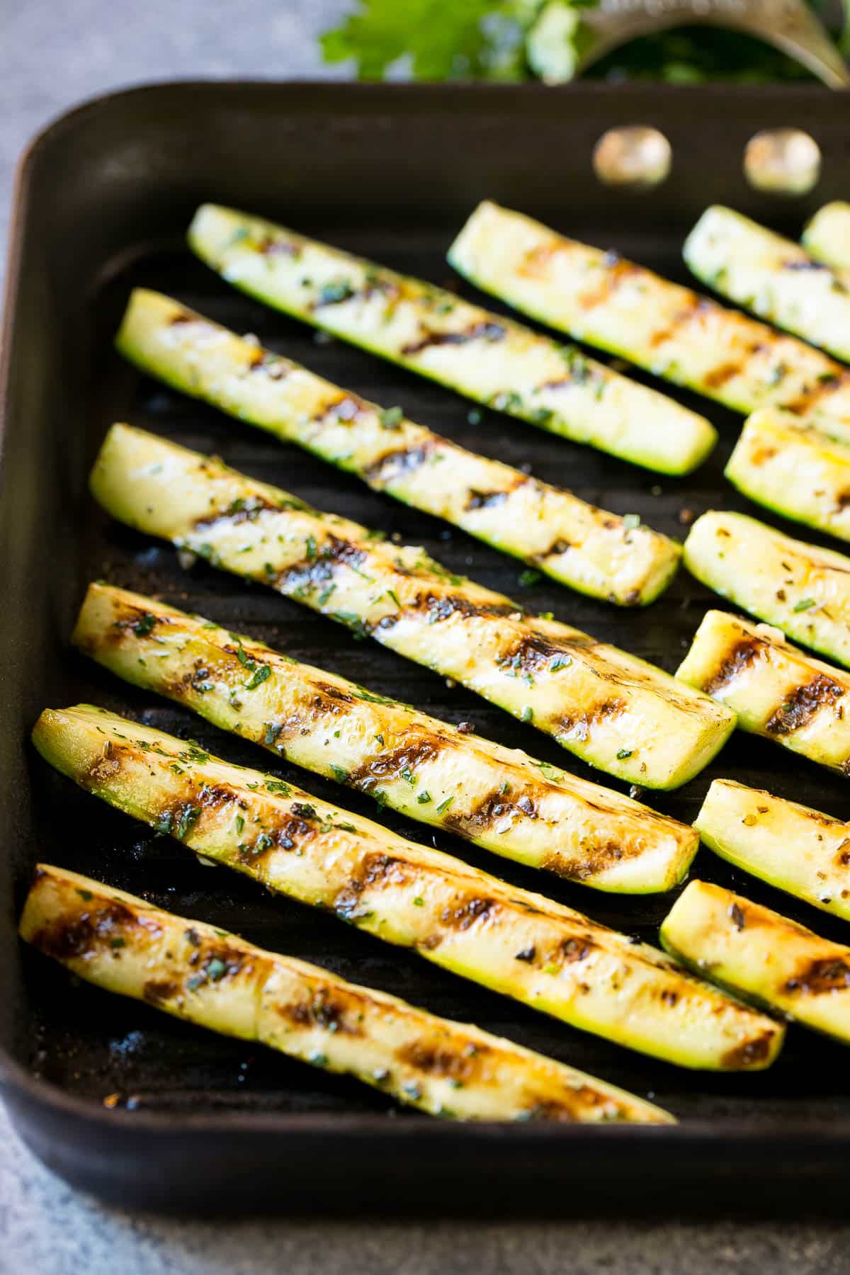 Zucchini spears cooked on a grill pan.