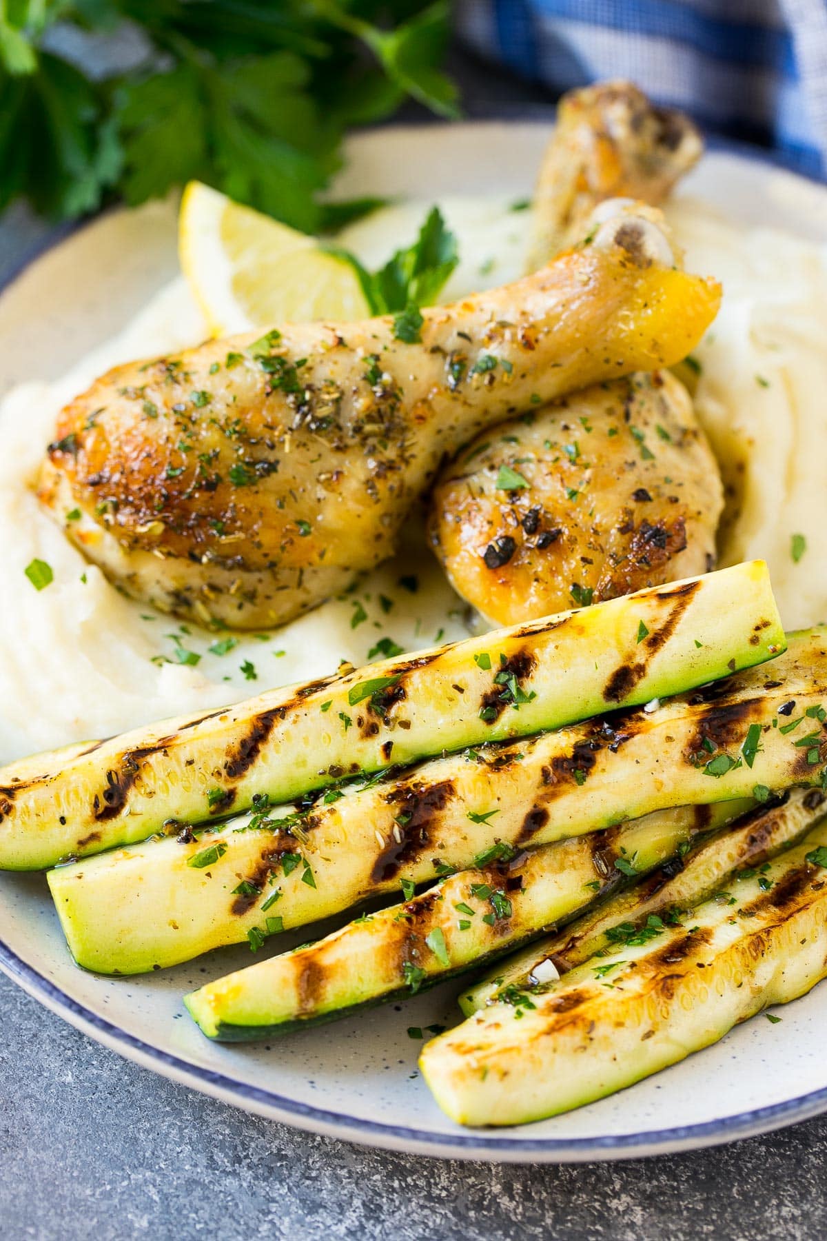 Grilled zucchini served with mashed potatoes and chicken.