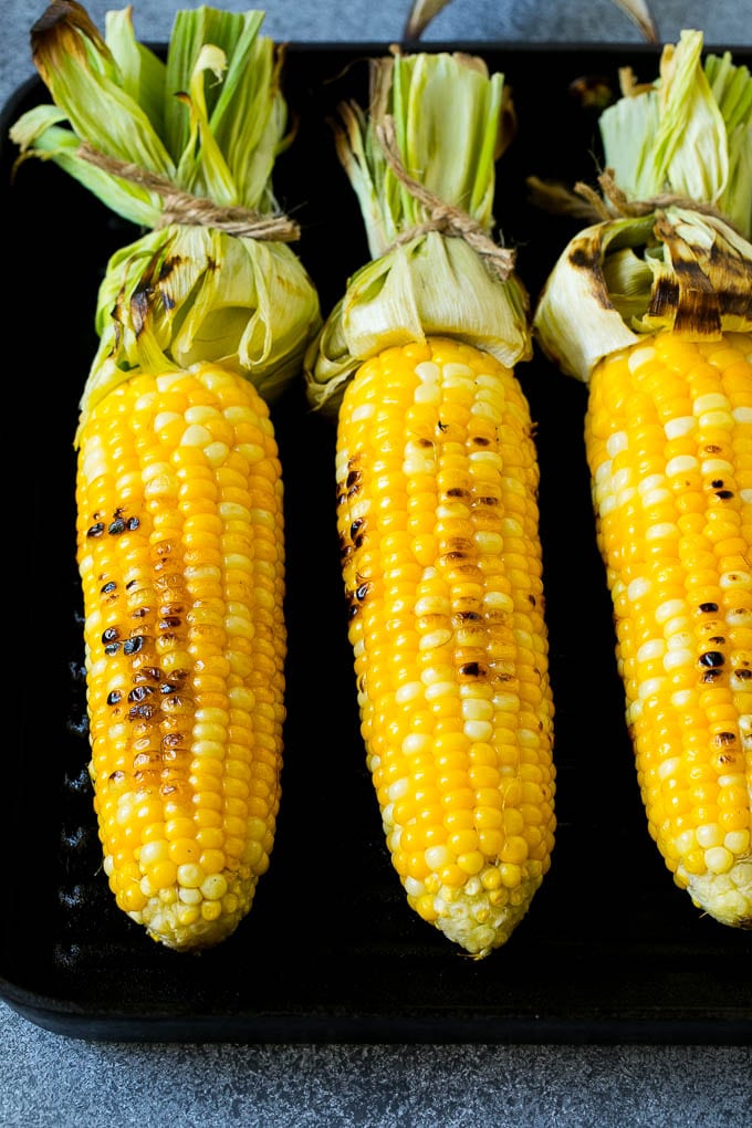 Corn cooking on a grill pan.