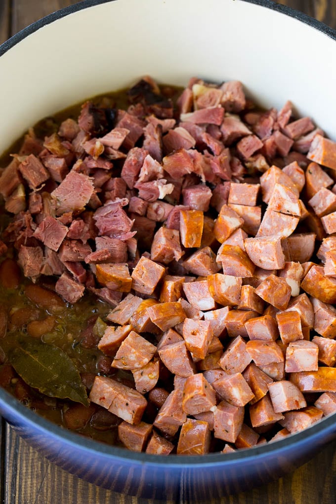 Cooked red beans topped with diced ham and sausage.