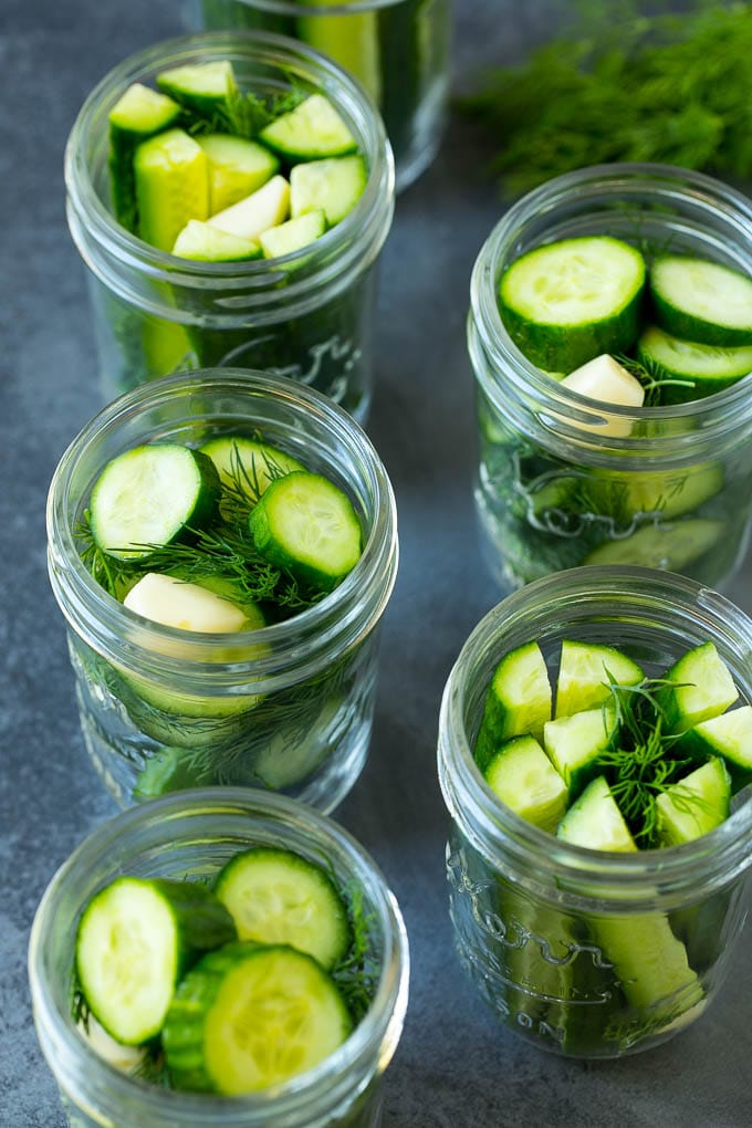Cucumbers in mason jars with fresh dill and garlic.