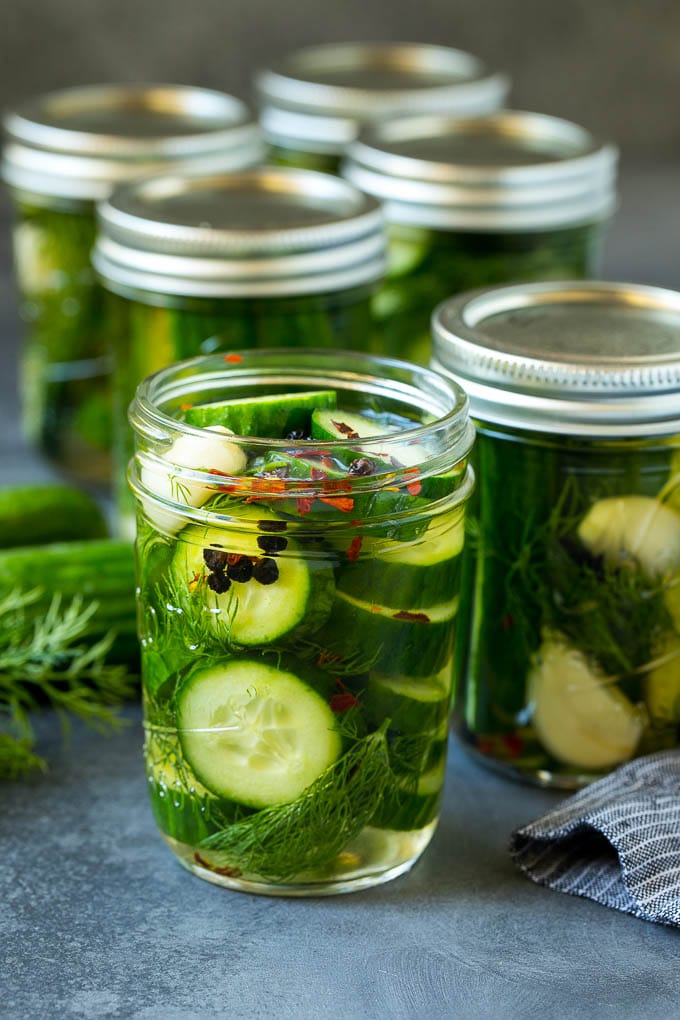 Sliced cucumbers in jars of brine.