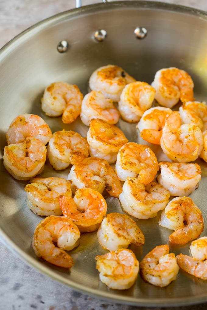 Cooked shrimp in a skillet.