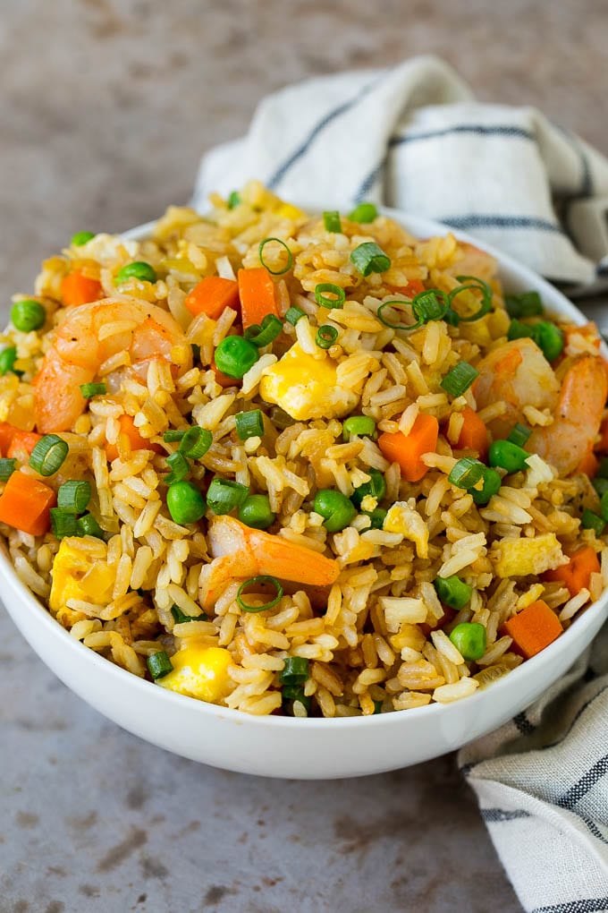A serving bowl filled with shrimp fried rice.