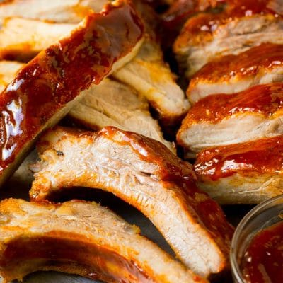 Sliced smoked ribs brushed with BBQ sauce.