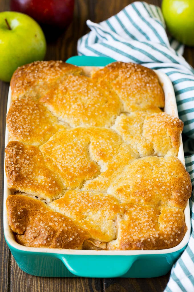 A dish of baked apple cobbler topped with sugar.